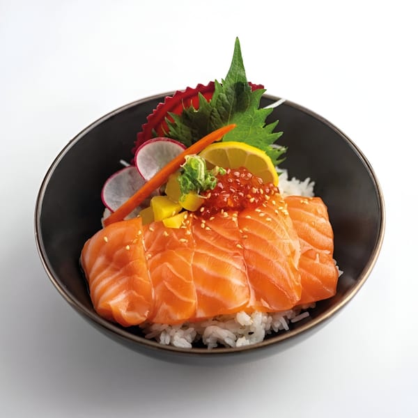 Mama M Sushi's salmon donburi with salmon sashimi, ikura, lemon, and vegetables over rice.